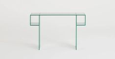 a glass and metal console table against a white background, with the top half covered in dots