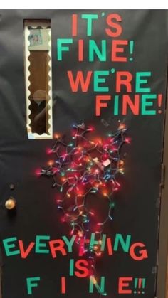 a door decorated with lights that says it's fine we're fine everything is fine