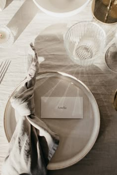 a place setting with silverware and napkins