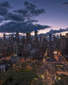 an aerial view of a city at night with the empire building in the center and other tall buildings