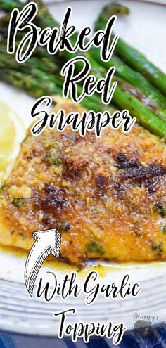 baked red snapper with garlic topping on a white plate next to asparagus