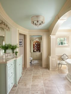 a large bathroom with an oval tub and chandelier