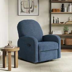 a blue recliner chair sitting in front of a book shelf