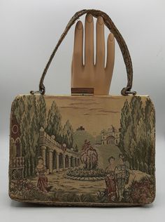 "Vintage Handbag by La Marquise Fine ItalianTapestry Purse 2 Inside Pockets A gorgeous vintage bag, measures 9 1/2\" x 7\" x 3\". The tapestry shows a detailed court yard with two females and a man.  Many stories can be thought about with this purse. Opens and closes easily and the zipper works just fine inside. Gently pre-owned in good vintage condition.  There is some wear on the corners and the top of the handle was coming apart and it looks like it was sewed a bit. Check out my store at #Fun Vintage Beige Satchel, Vintage Rectangular Bags For Vintage Events, Vintage Rectangular Bags For Events, Vintage Evening Bag In Tapestry Material, Vintage Tapestry Bag For Evening, Vintage Tapestry Bag For Formal Occasions, Vintage Tapestry Travel Bag, Vintage Formal Tapestry Bag, Vintage Beige Satchel With Top Carry Handle