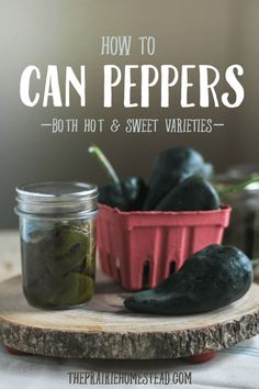 two jars filled with green peppers sitting on top of a wooden tray next to each other