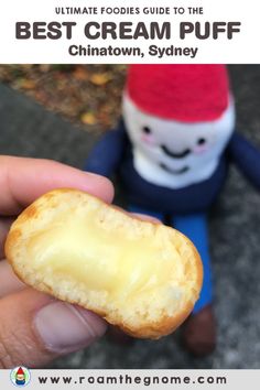 someone holding a piece of bread in their hand with the caption, ultimate guide to the best cream puff chinatown, sydney