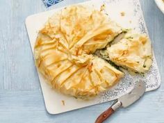 a pie on a cutting board with a knife next to it