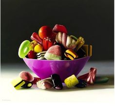 a purple bowl filled with lots of candy