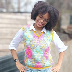 a woman wearing glasses and a sweater vest