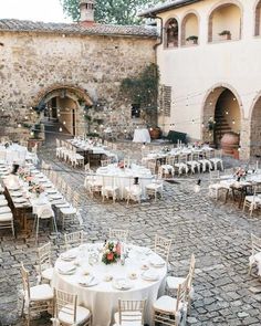 an outdoor wedding venue with tables and chairs