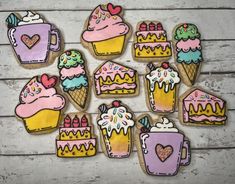 decorated cookies with frosting and icing are arranged on a table