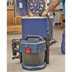 a man is using a machine to clean the floor