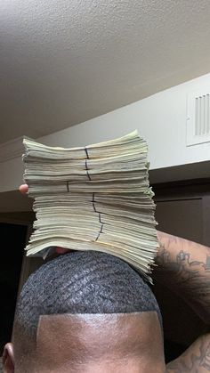 a man with his head covered in bills