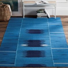 a blue area rug in a living room