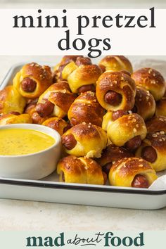 mini pretzel dogs on a plate with dipping sauce