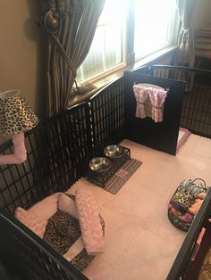 a baby's crib in the corner of a room with several items on it