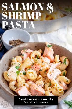 salmon and shrimp pasta in a bowl on a white tablecloth with the title, salmon & shrimp pasta restaurant quality food at home