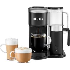 the keurig coffee maker is next to two cups of coffee and an espresso machine