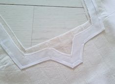 a piece of white fabric with some stitching on it