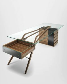 a desk with a glass top and wooden legs