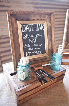 a wooden box with two jars on it and a chalkboard sign in the middle