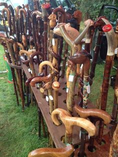 many different types of wooden canes on display