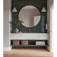 a bathroom with a round mirror on the wall