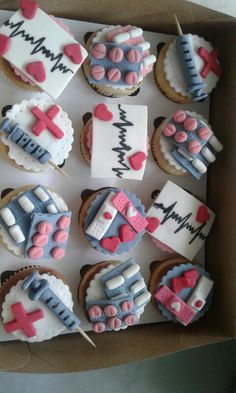 a box filled with lots of cupcakes decorated like medical equipment and nurse's symbols