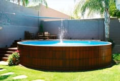 an above ground pool in the middle of a yard with steps leading up to it