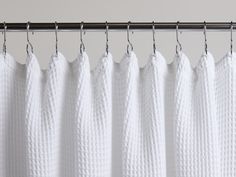 white curtains hanging on a metal rod