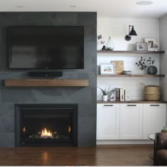 a flat screen tv mounted above a fireplace in a living room