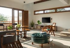 a living room filled with furniture and a flat screen tv mounted to the side of a wall