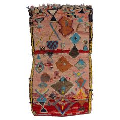 an old rug with many different colors and designs on it's sides, including the middle