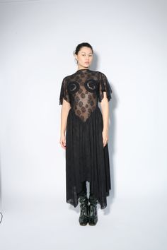 NOTE: This is a PRE-ORDER purchase. This piece is expected to ship Mid/late December 2024. This long lace dress exudes prima donna excellence with its princess waist cut, intricate detailing on the chest, and graceful boat neck. The addition of frivolous lace sleeves adds a touch of romantic charm, making it an unexpected choice for formal occasions. Fitted Lace Dress With Lace Patchwork For Evening, Gothic Sheer Lace Dress, Sheer Lace Gothic Dress, Fitted Lace Dress With Patchwork For Gala, Gothic Short Sleeve Dress With Lace Trim, Lace Patchwork Evening Dress, Lace Evening Dress With Lace Trim, Lace Dress For Evening, Lace Top Midi Dress For Evening