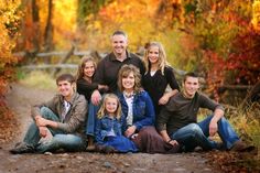 a family posing for a photo in the fall