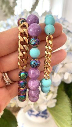 A fun colorful trio of three bracelets...You will receive in this set-1-a gold fill curb chain with coated lava rocks2-matte turquoise stones with a gold fill curb chain3-light purple jade bracelet with scattered lava rocks.Select size needed and please message for other sizes. Handmade Jewelry Diy Bracelets, Bracelet Trio, Faberge Jewelry, Turquoise Bead Bracelet, Purple Jade, Diy Bracelet Designs, Bracelet Display, Beads Bracelet Design, Handmade Fashion Jewelry