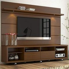 a large entertainment center with a flat screen tv mounted on it's side wall