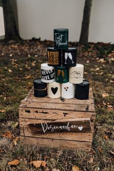 a wooden crate filled with lots of different types of coffee cups on top of it