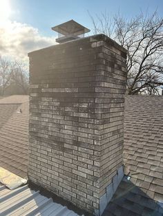 an old brick chimney on top of a roof