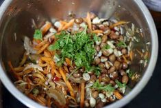 a metal bowl filled with lots of food