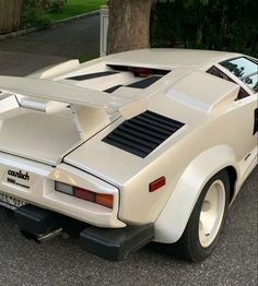 a white car is parked on the street