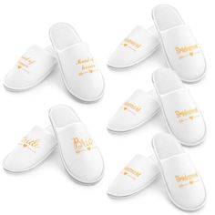 six white slippers with yellow lettering on them