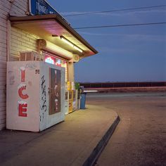 a vending machine sitting in front of a building