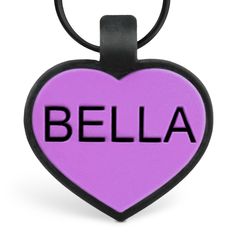 a black and purple heart shaped key chain with the word bella on it's front