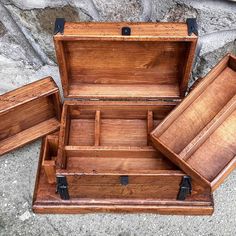 three wooden boxes sitting on the ground next to each other, one empty and one open