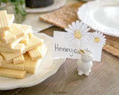 a small white bunny figurine next to some waffles on a plate