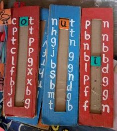 three wooden blocks with letters and numbers on them sitting next to each other in a pile