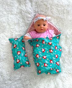 a baby doll laying on top of a bed