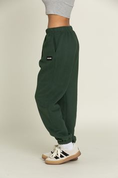 Elevate your athleisure style and feel like you're lounging on the go with our Hunter Green GH Jogger Sweatpants. The elastic waistband and tapered leg style allows you to feel secure and trendy. Complete with dual side pockets to keep your essentials close by. Pair with ur Hunter Green GH Cropped Hoodie to complete the set. Affordable Green Athleisure Sweatshirt, Green Sweats Outfit, Sweats Outfit, Green Sweatpants, Athleisure Style, Green Joggers, Tennis Skirts, Athleisure Fashion, Athletic Top