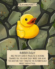 a yellow rubber ducky floating on top of a rock covered ground next to a sign that says rubber ducky